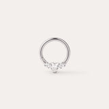 A Crystal Heart Titanium Daith Ring in Platinum, featuring a central heart-shaped gemstone flanked by two smaller round gemstones on each side, displayed on a plain light background. Crafted from implant-grade titanium with a platinum PVD finish, this hypoallergenic daith ring combines elegance with comfort for everyday wear.