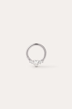 A Crystal Heart Titanium Daith Ring in Platinum, featuring a central heart-shaped gemstone flanked by two smaller round gemstones on each side, displayed on a plain light background. Crafted from implant-grade titanium with a platinum PVD finish, this hypoallergenic daith ring combines elegance with comfort for everyday wear.