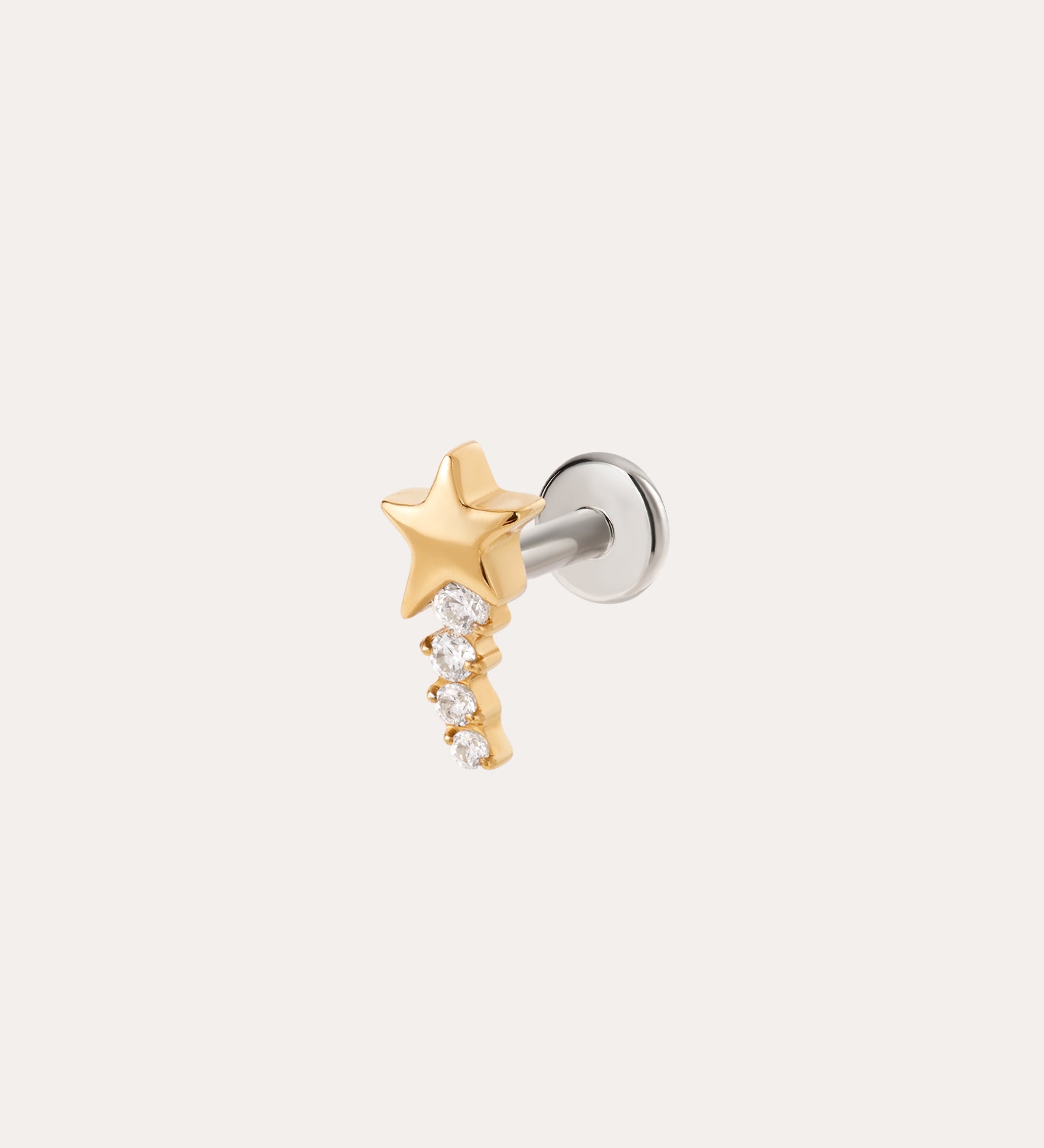 Introducing the Crystal Shooting Star Threadless Flat Back Titanium Cartilage Stud in Yellow Gold PVD—a sleek gold star earring featuring five small clear gemstones arranged in a graceful, descending curve. This dazzling piece is attached to a silver post and showcased on a simple light background, evoking the brilliance of a crystal shooting star.