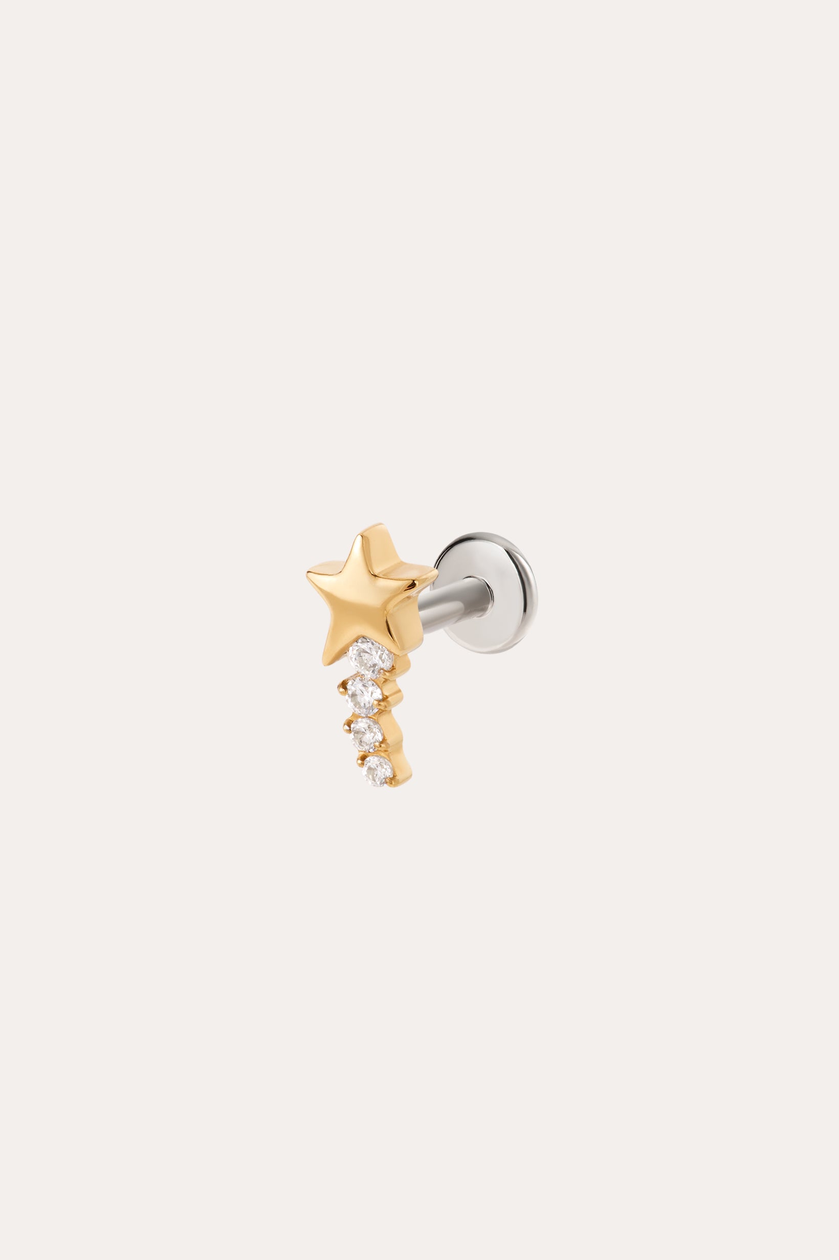 Introducing the Crystal Shooting Star Threadless Flat Back Titanium Cartilage Stud in Yellow Gold PVD—a sleek gold star earring featuring five small clear gemstones arranged in a graceful, descending curve. This dazzling piece is attached to a silver post and showcased on a simple light background, evoking the brilliance of a crystal shooting star.