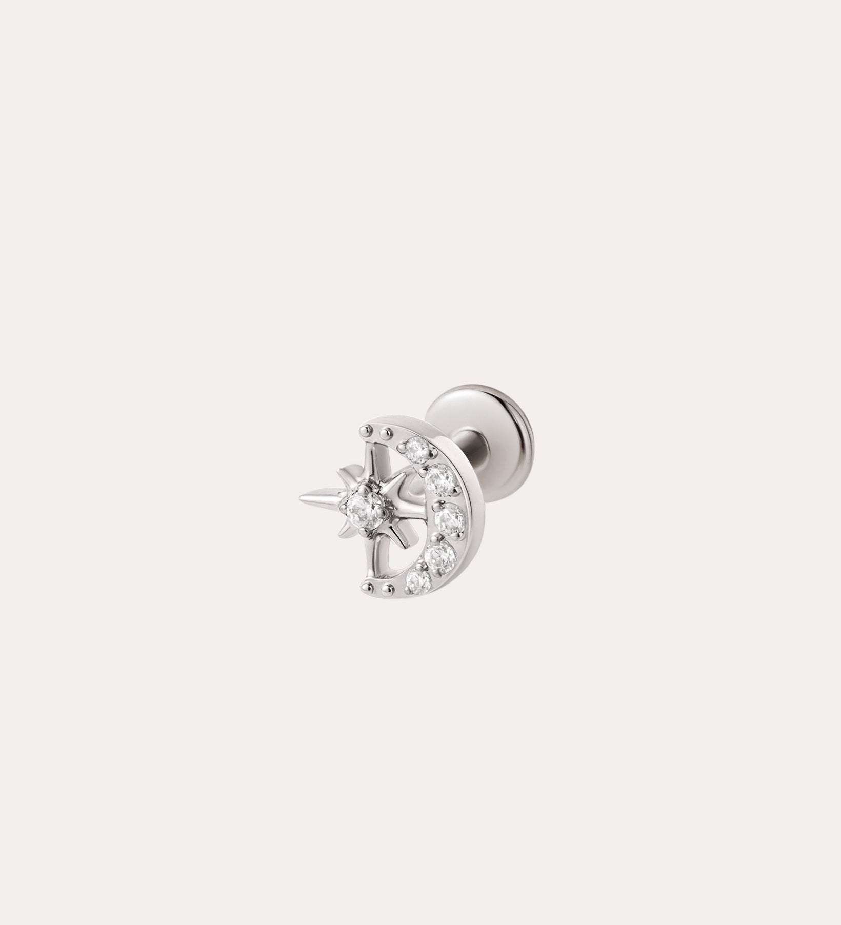 The Celestial Spark Threadless Flat Back Titanium Cartilage Stud in Platinum, featuring a crescent moon and star design accented with small clear gemstones, is shown against a plain light background. This stunning, hypoallergenic earring in platinum PVD ensures comfortable wear with its threadless flat back design.