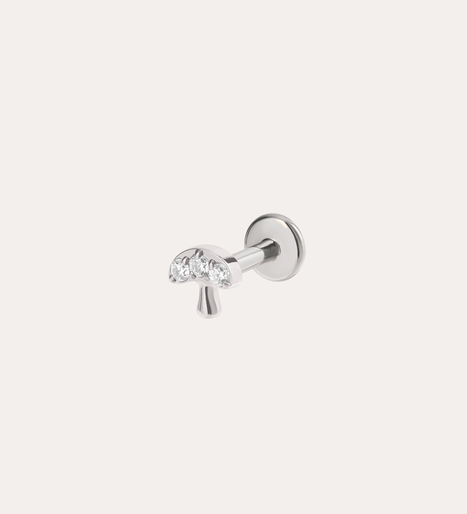 The Crystal Mushroom Threadless Flat Back Titanium Cartilage Stud in Platinum PVD features three clear gemstones in the cap and is hypoallergenic. This whimsical platinum earring is displayed on a plain white background.