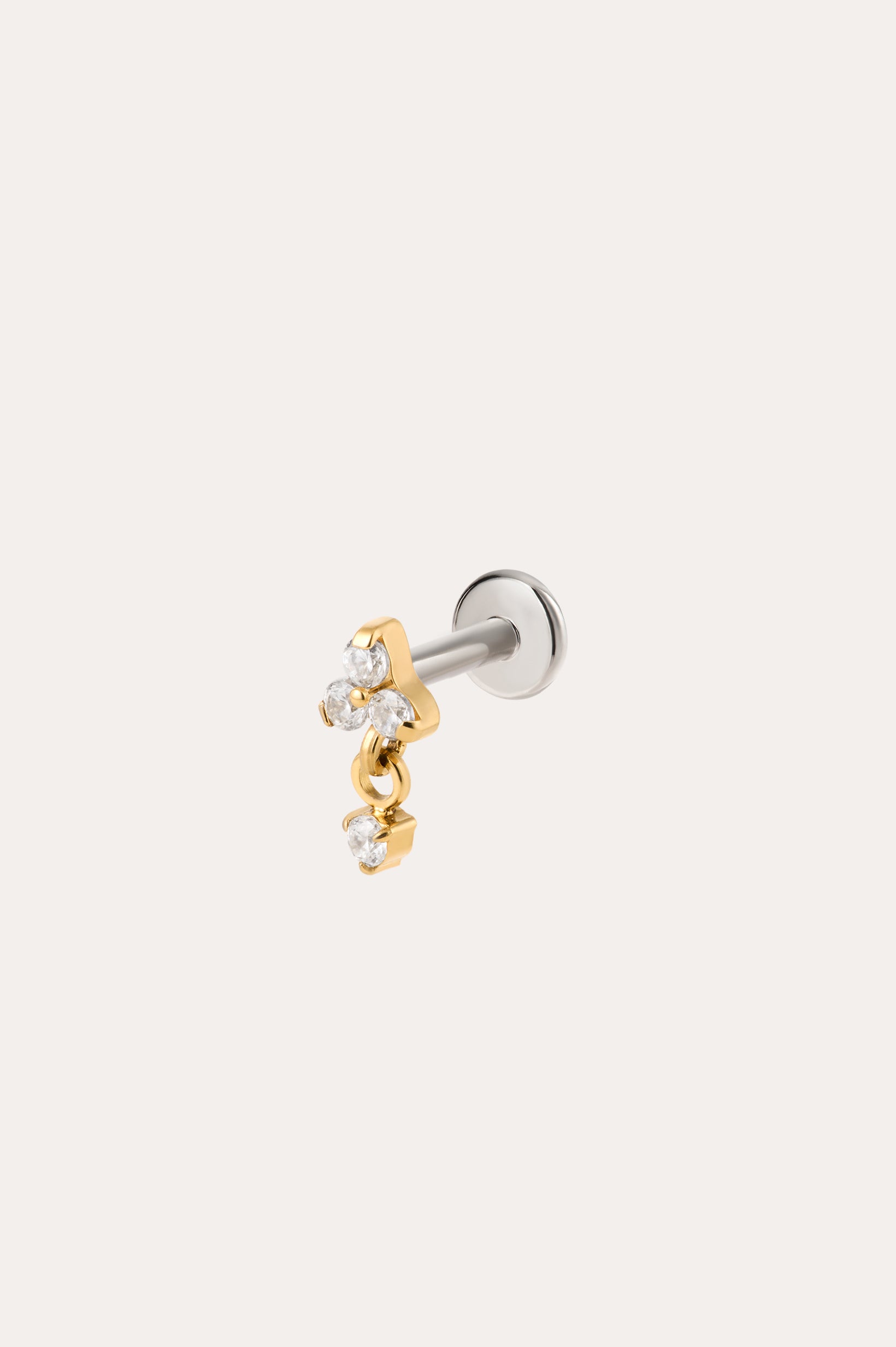 The Crystal Dangle Threadless Flat Back Titanium Cartilage Stud in Gold, shown in yellow gold PVD, features a sleek barbell design with a gold star charm and three small clear gemstones. A dangling cluster of gold and crystals adds sparkle, while the threadless flat back ensures comfortable wear. The earring is photographed against a plain white background, highlighting its elegant crystal dangle style.