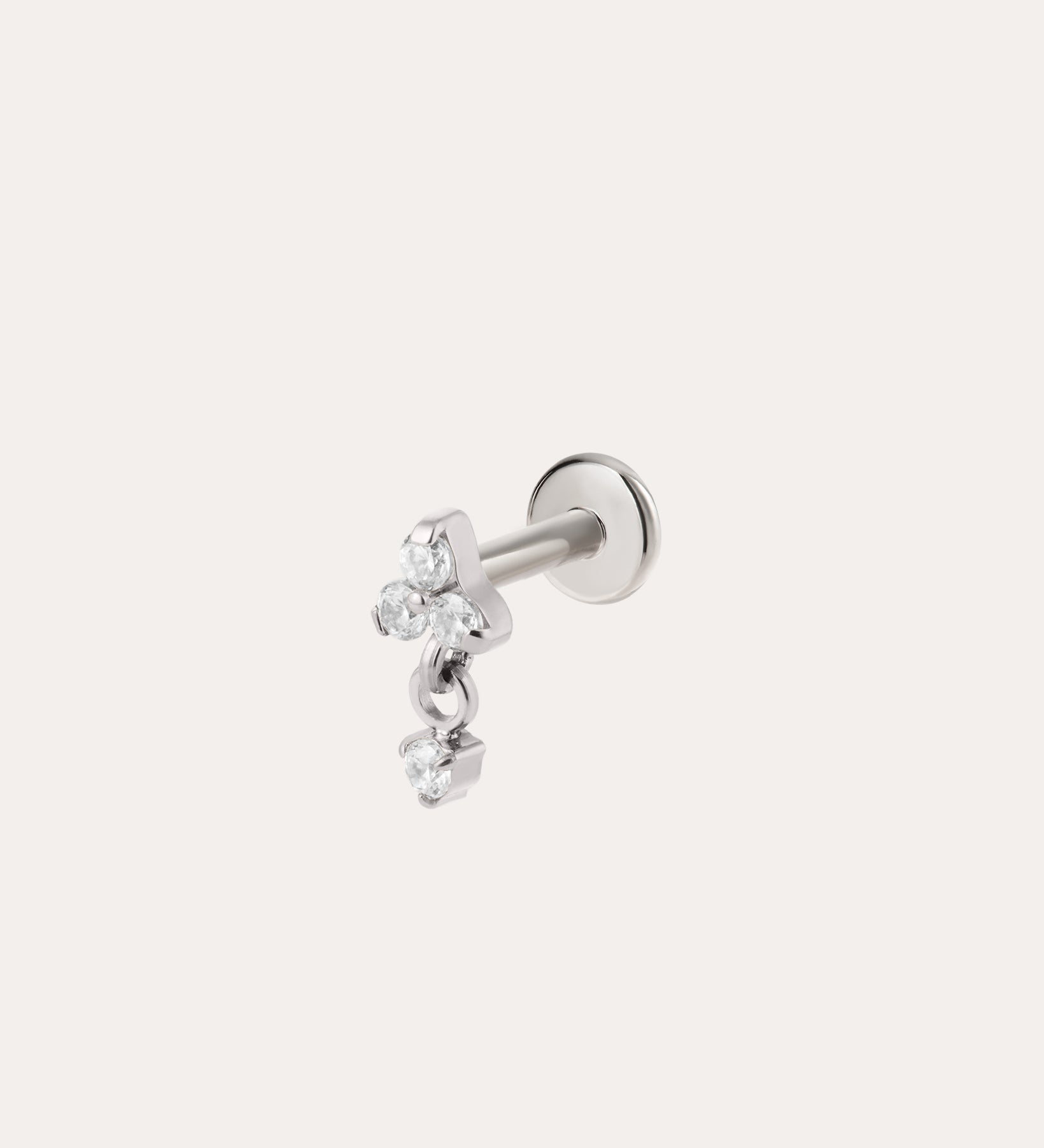 The Crystal Dangle Threadless Flat Back Titanium Cartilage Stud in Platinum features three small, clear gemstones arranged in a delicate cluster on a platinum PVD finish—an elegant example of hypoallergenic piercing jewelry designed for everyday comfort.