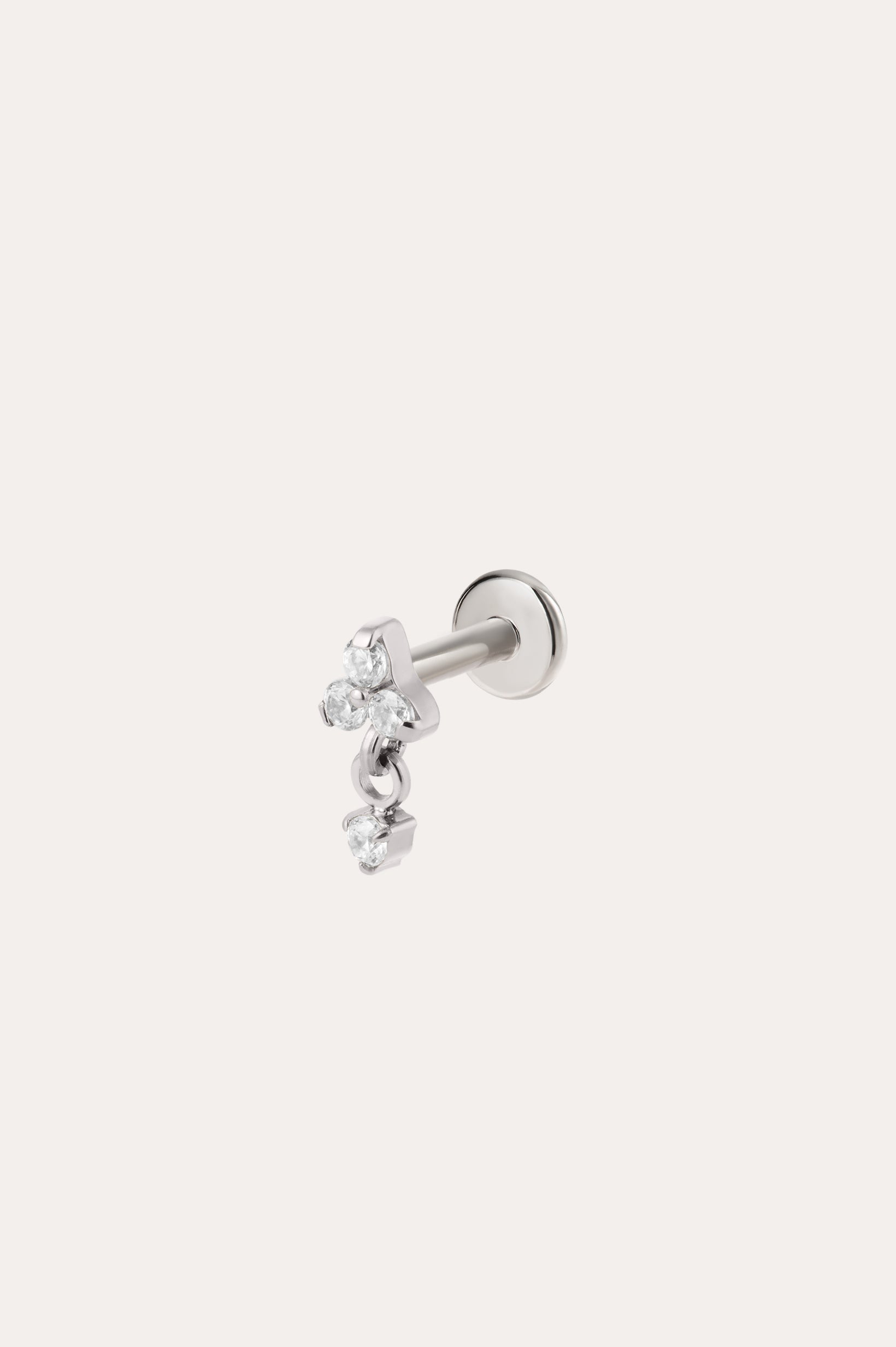 The Crystal Dangle Threadless Flat Back Titanium Cartilage Stud in Platinum features three small, clear gemstones arranged in a delicate cluster on a platinum PVD finish—an elegant example of hypoallergenic piercing jewelry designed for everyday comfort.