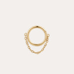 The Chain Clicker Titanium Ring in Gold showcases a hoop linked to a smaller hoop by a delicate yellow gold PVD chain, combining hypoallergenic elegance and displayed on a simple light background.
