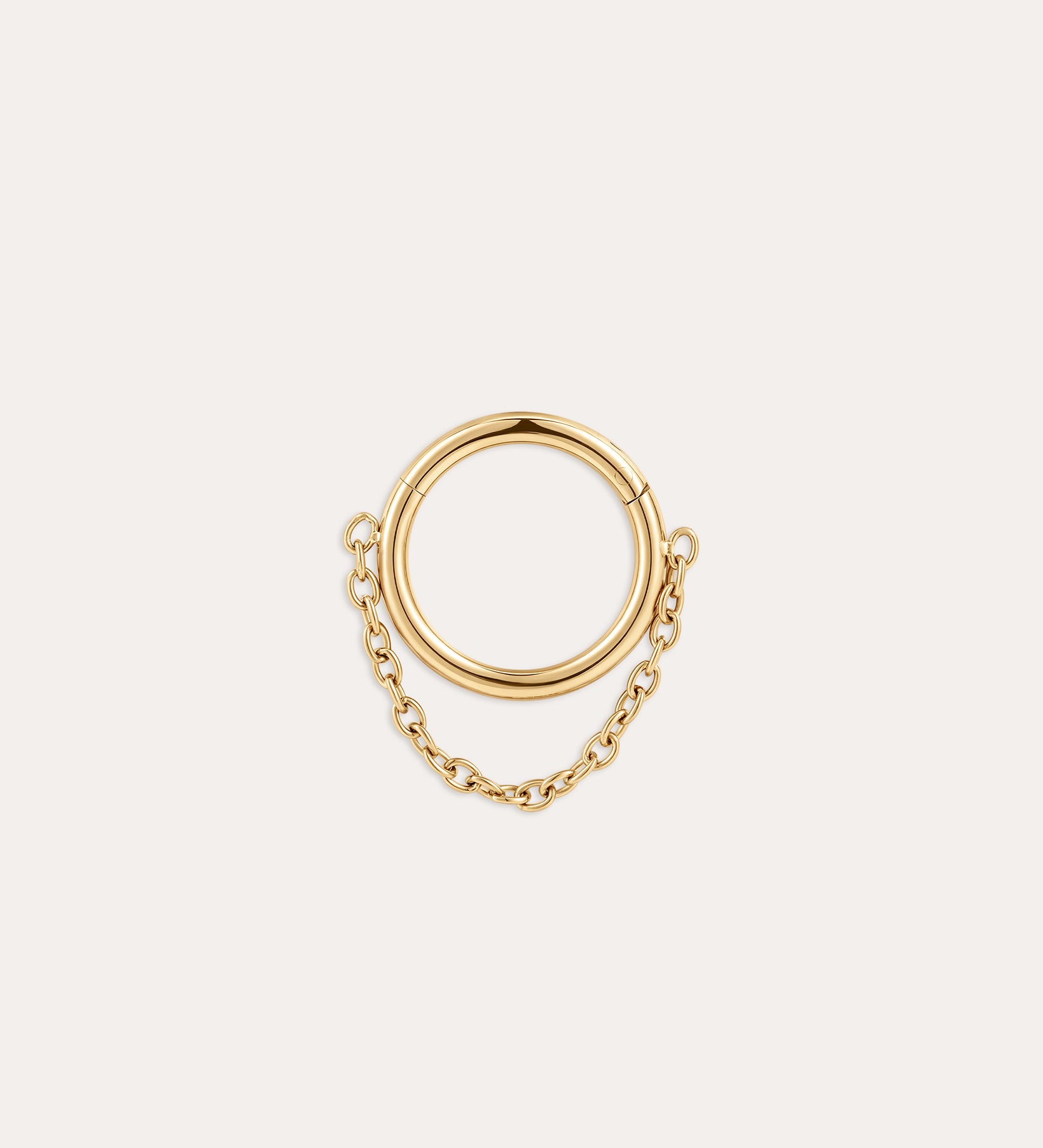 The Chain Clicker Titanium Ring in Gold showcases a hoop linked to a smaller hoop by a delicate yellow gold PVD chain, combining hypoallergenic elegance and displayed on a simple light background.