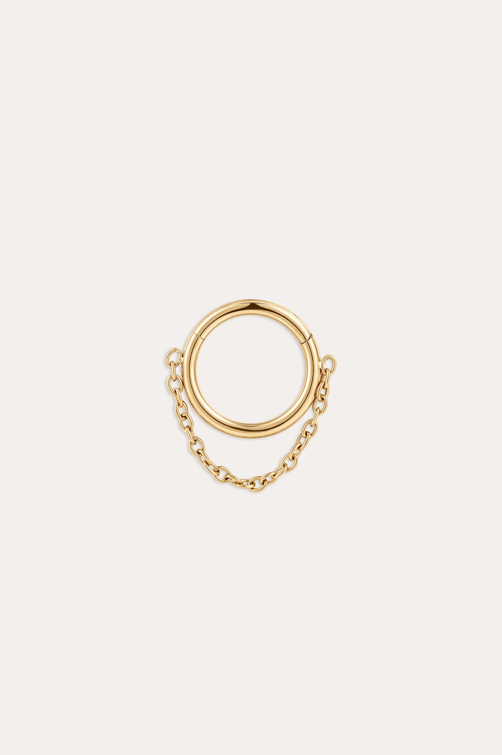 The Chain Clicker Titanium Ring in Gold showcases a hoop linked to a smaller hoop by a delicate yellow gold PVD chain, combining hypoallergenic elegance and displayed on a simple light background.