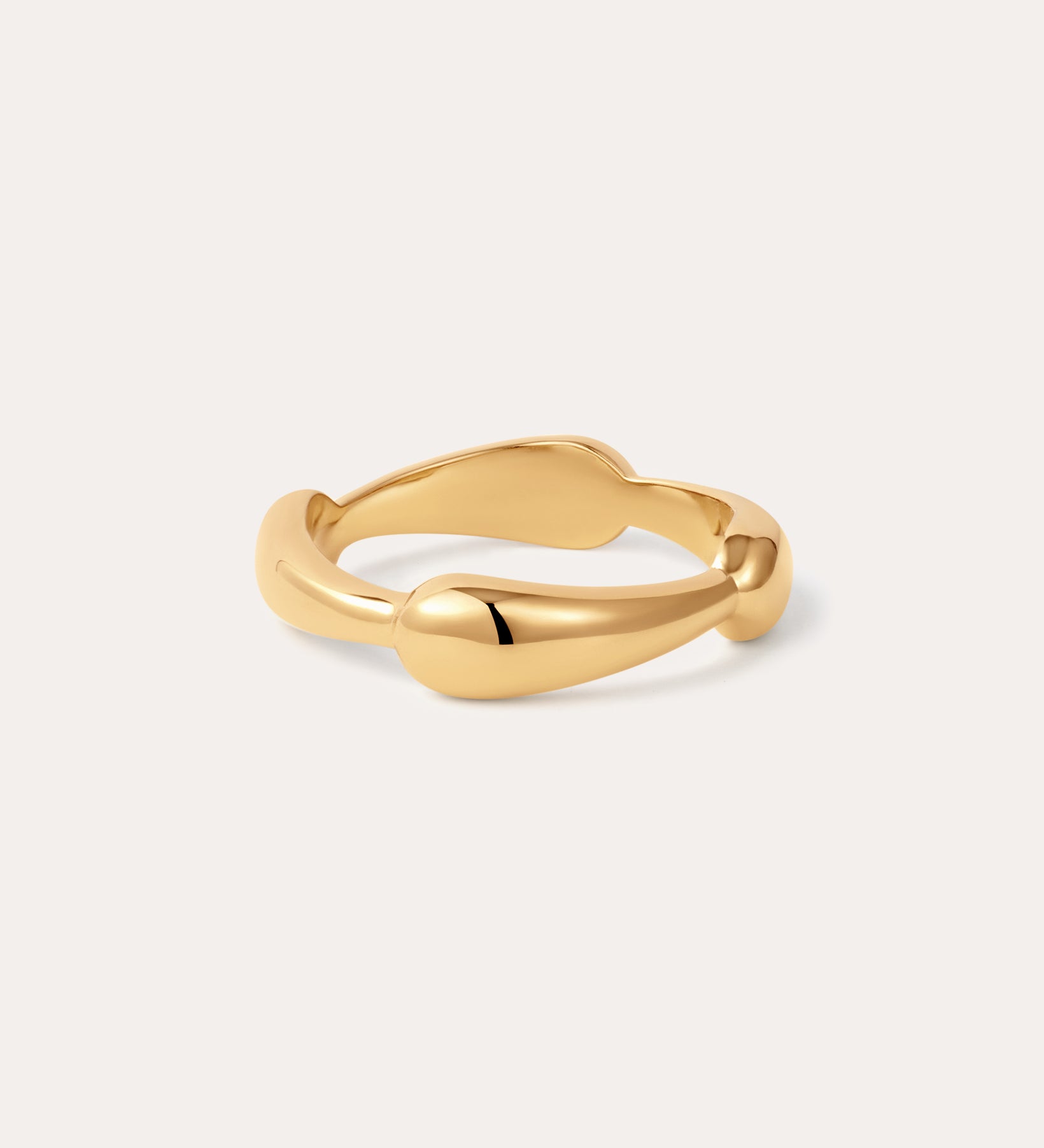 The Colette Link Droop Ring in 18k Gold Plated features a smooth, organic design with gentle curves; displayed on a simple, light background, it’s a refined statement ring for any occasion.