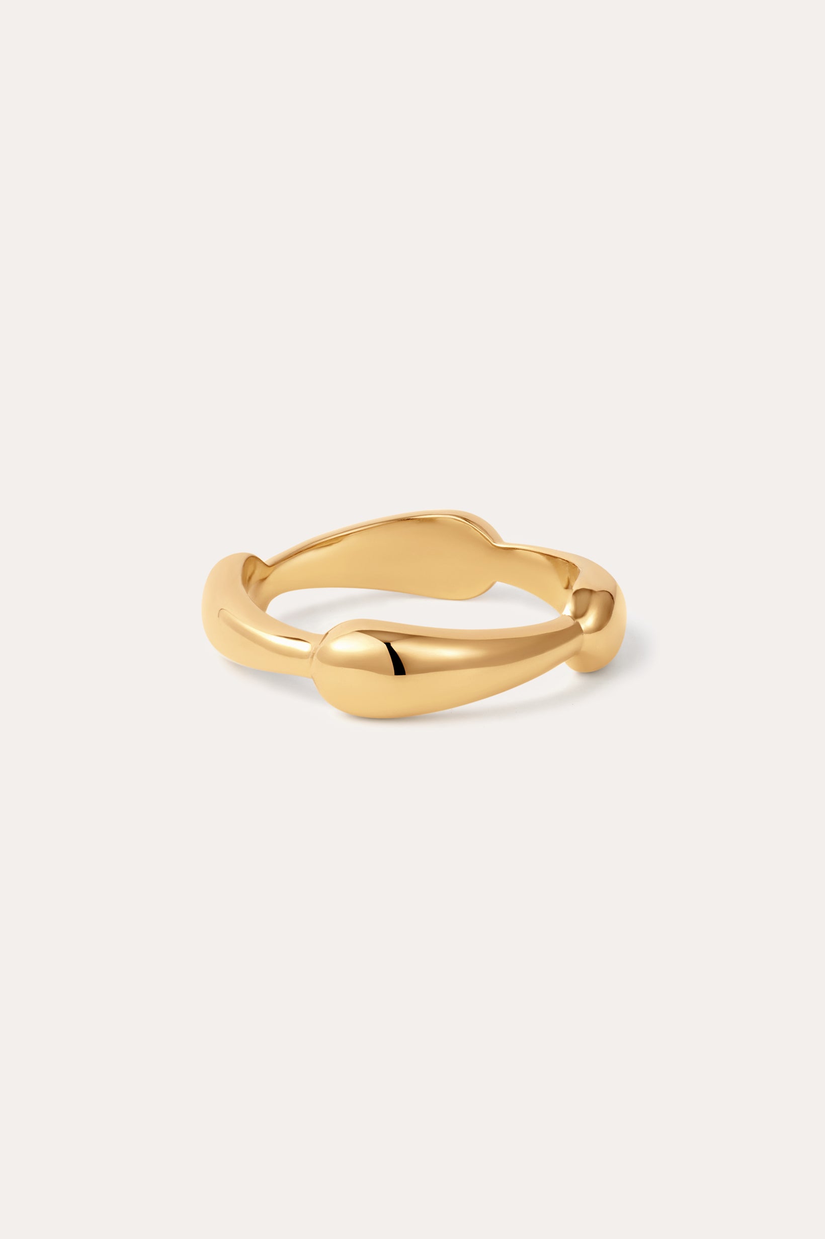 The Colette Link Droop Ring in 18k Gold Plated features a smooth, organic design with gentle curves; displayed on a simple, light background, it’s a refined statement ring for any occasion.