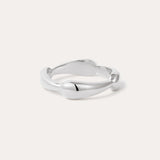 The Colette Link Droop Ring in Silver features a minimalist design with a smooth, slightly irregular band and rounded ends, shown against a light background.