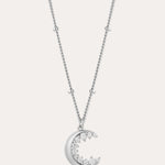 The Crescent Moon Crystal Charm Beaded Necklace in Silver features a delicate beaded chain and a crescent moon pendant adorned with sparkling clear stones.