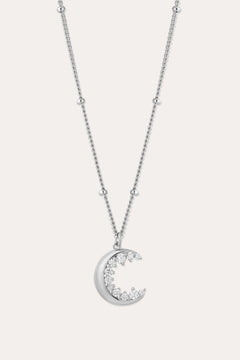 The Crescent Moon Crystal Charm Beaded Necklace in Silver features a delicate beaded chain and a crescent moon pendant adorned with sparkling clear stones.
