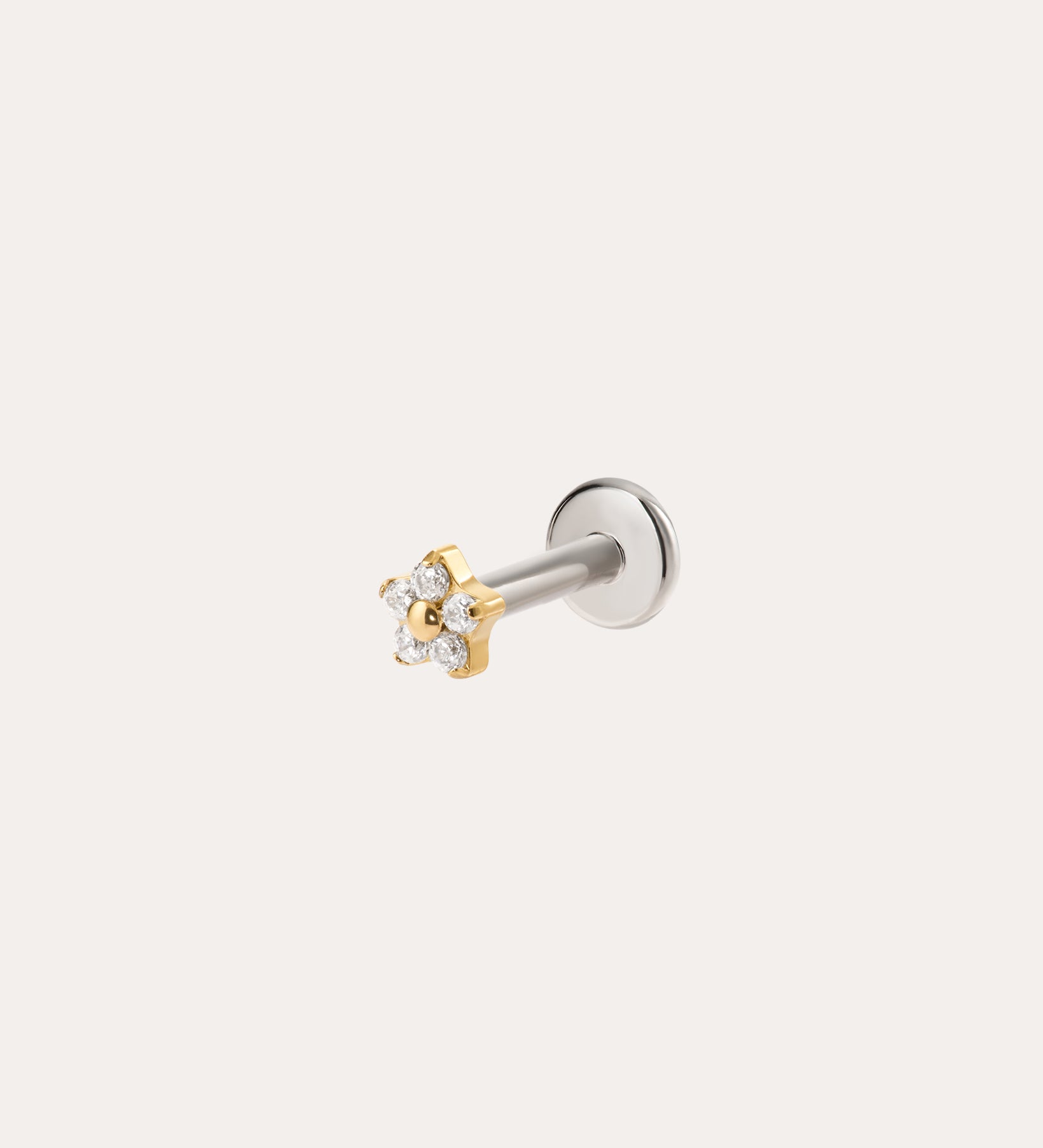 The Crystal Flower Threadless Flat Back Titanium Cartilage Stud in Gold features a Yellow Gold PVD finish and sparkling clear gemstones on a silver post, displayed against a plain light background.