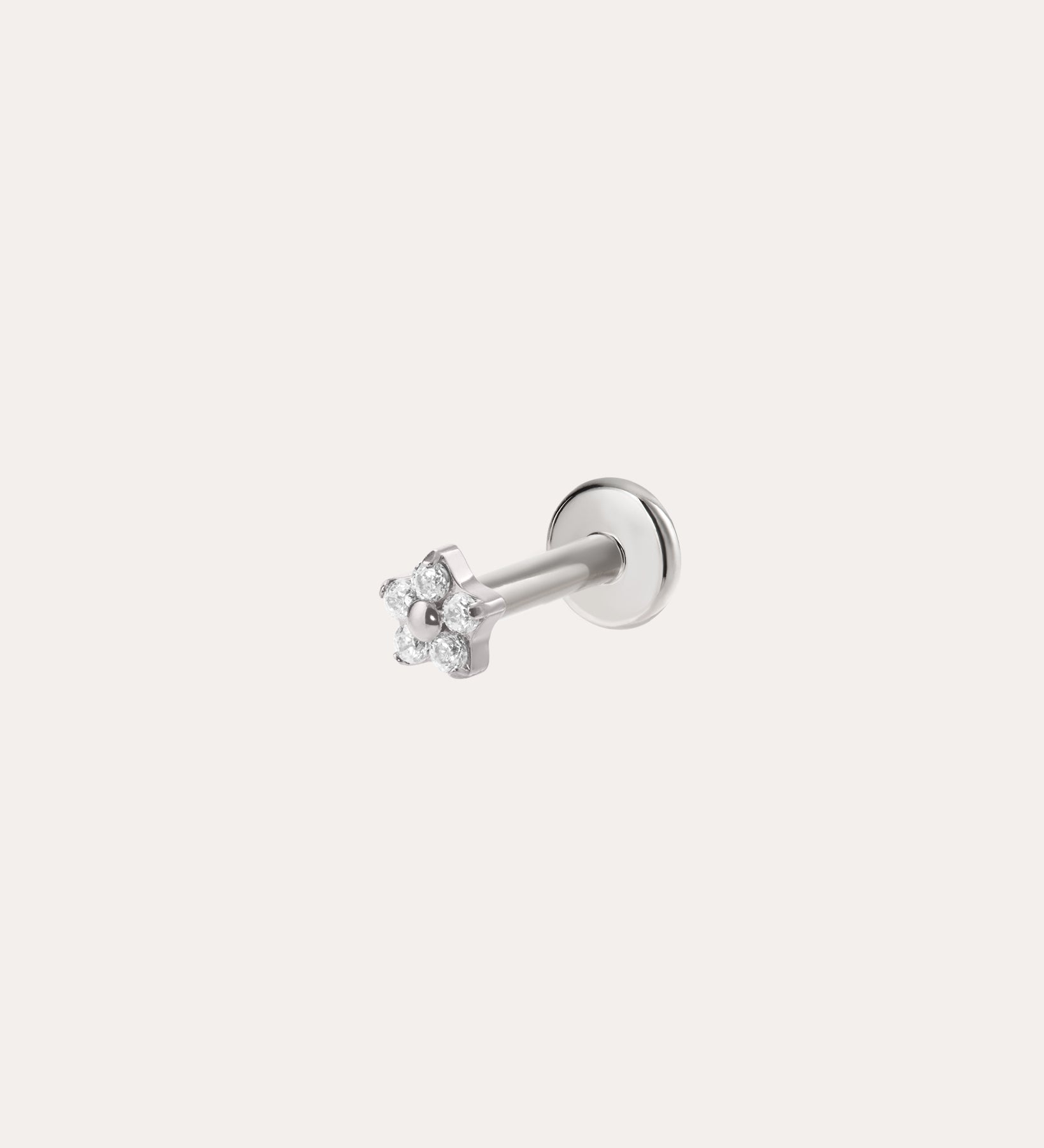 The Crystal Flower Threadless Flat Back Titanium Cartilage Stud in Platinum features a platinum PVD finish and clear gemstones, shown against a simple background—perfect as hypoallergenic piercing jewelry.
