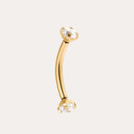 The Crystal Titanium Rook Barbell in Gold features a curved yellow gold PVD design with clear gemstones in prong settings at both ends, displayed against a simple light background.