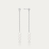 Pair of pearl drop earrings on a light gray background