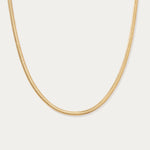 The Estelle Herringbone Chain Necklace in Gold is shown against a plain white background.