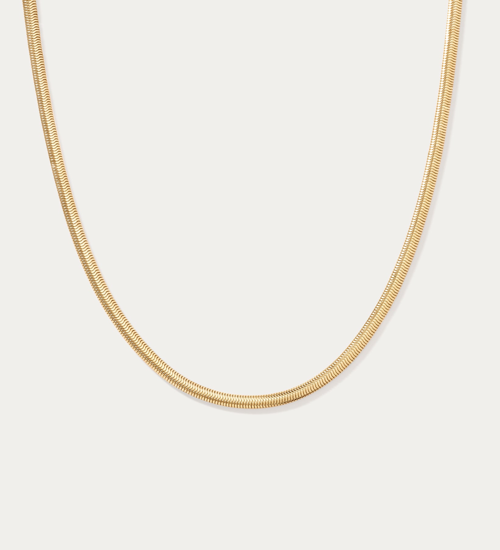 The Estelle Herringbone Chain Necklace in Gold is shown against a plain white background.