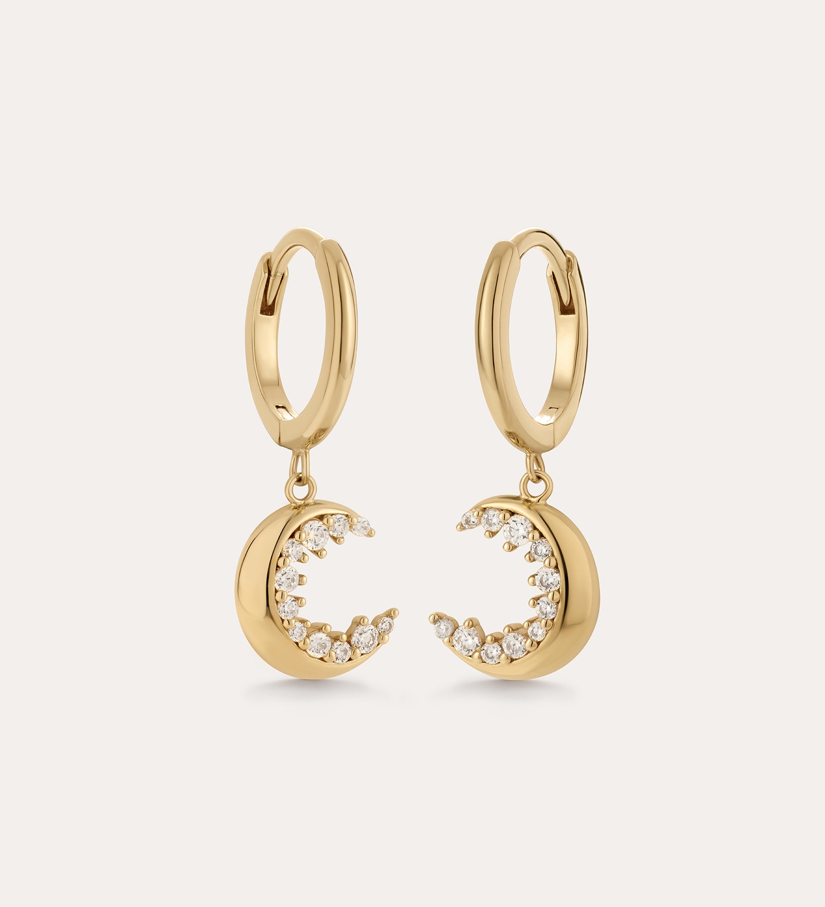 Crescent Moon Crystal Charm Huggies in Gold, featuring crescent moon charms with sparkling cubic zirconia, displayed on a plain light background.