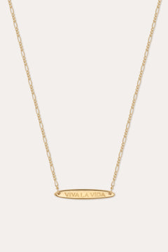 The Viva La Vida Bar Chain Necklace in Gold features an oval horizontal pendant engraved with VIVA LA VIDA on an adjustable delicate figaro chain for the perfect fit.