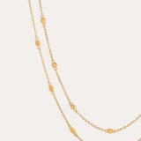 The Simona Double Chain Stacking Necklace in Gold features delicate oval-shaped accents spaced evenly along its length, ideal for stacking or layering, and is shown against a simple, light background.