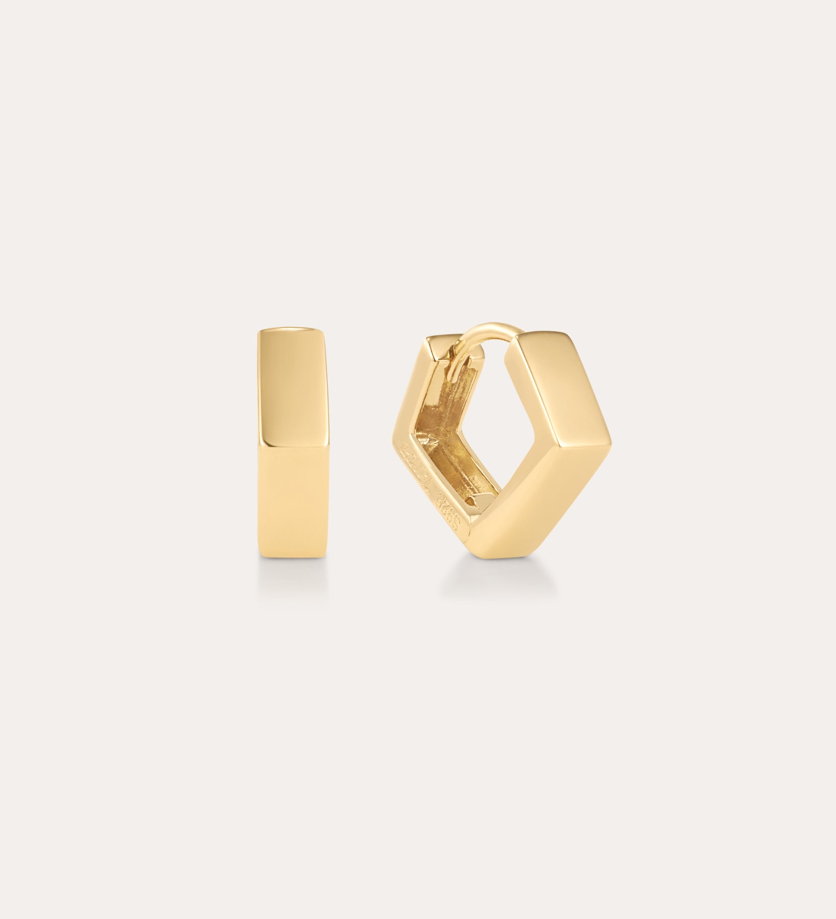 The Judith Hexagon Angular Huggies in Gold are 18k gold plated hoop earrings with a modern, angular design, shown against a light background—one earring is front-facing, the other highlights its side profile and clasp.