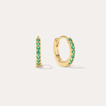 The Kiki Crystal Huggie Earrings in 18k Gold Plated/Green feature a row of green crystals on each earring, with one shown from the side and one from the front—versatile, stylish options for daily wear.