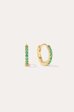 The Kiki Crystal Huggie Earrings in 18k Gold Plated/Green feature a row of green crystals on each earring, with one shown from the side and one from the front—versatile, stylish options for daily wear.