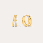 Kira Crystal Double Hoop Huggies in 18k Gold Plated, featuring a row of clear round crystals along the front, are displayed against a plain off-white background.