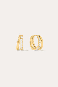 Kira Crystal Double Hoop Huggies in 18k Gold Plated, featuring a row of clear round crystals along the front, are displayed against a plain off-white background.