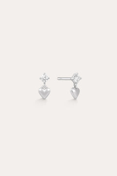 The Lilian Crystal Heart Studs Earrings in Silver feature a sparkling star-shaped gemstone above a dangling silver heart charm—perfect dainty earrings for any occasion.