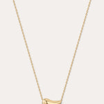 Gold necklace with a small pendant on a light gray background