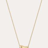Gold necklace with a small pendant on a light gray background