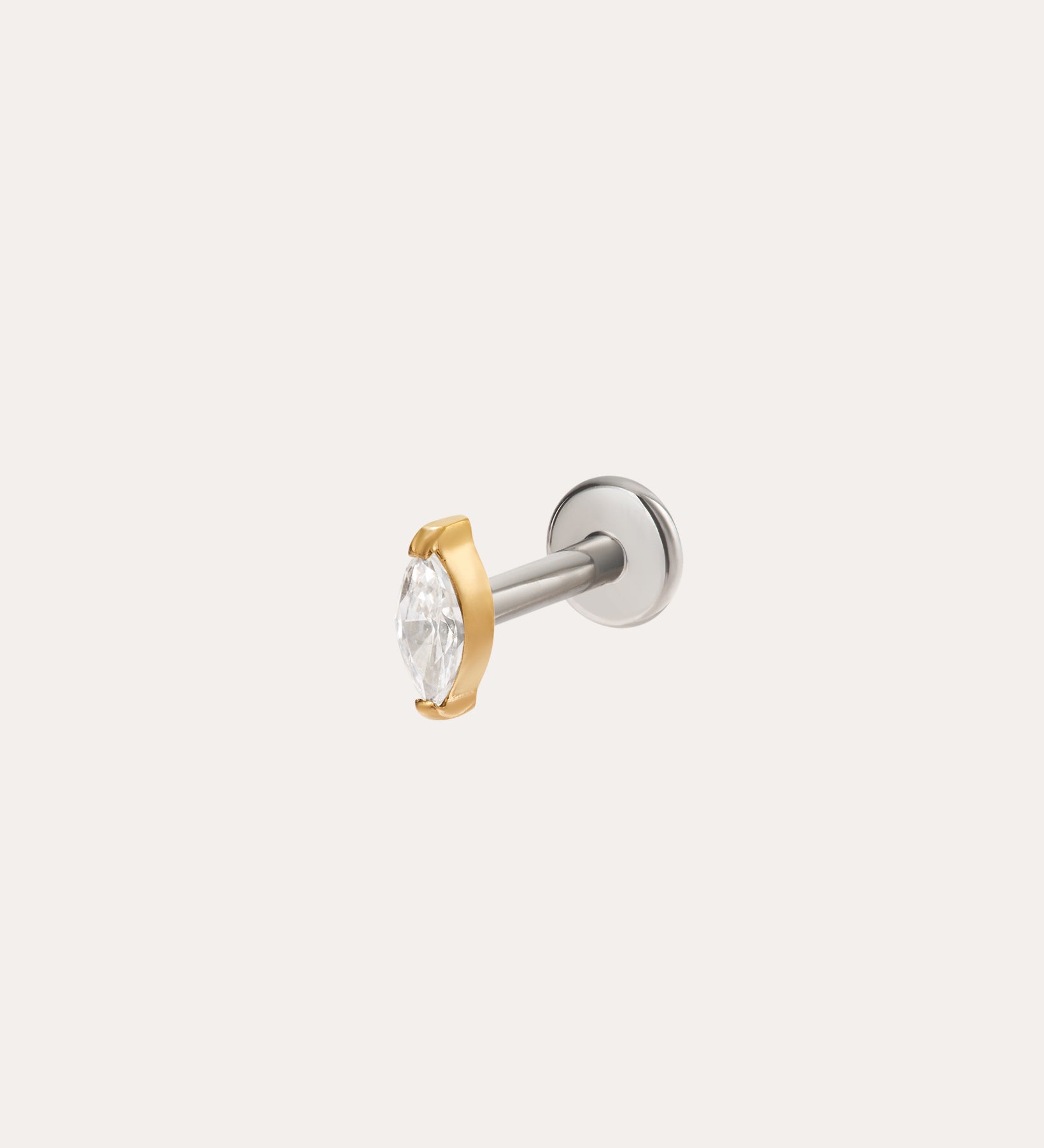 The Marquise Threadless Flat Back Titanium Cartilage Stud in Gold features a clear marquise gemstone in a gold prong setting with a silver titanium post, shown against a plain light background.