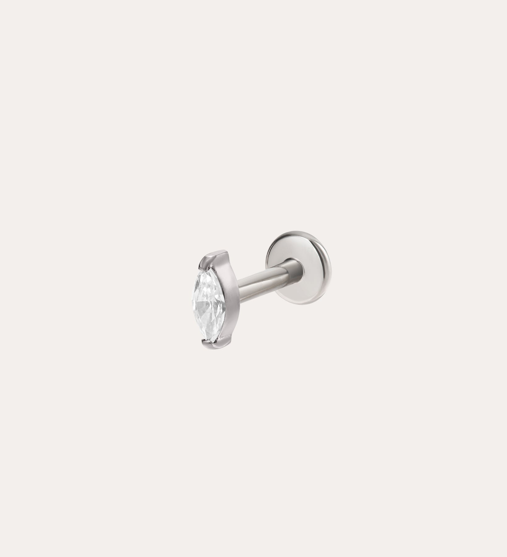 A Marquise Threadless Flat Back Titanium Cartilage Stud in Platinum PVD, featuring a round clear gemstone held by prongs, is displayed against a plain white background.