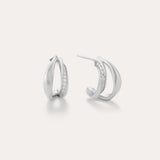 Nadine Pavé Twisted Stud Earrings in Silver feature lightweight, asymmetrical silver hoops with a row of sparkling stones along the inner curve, displayed on a plain white background.