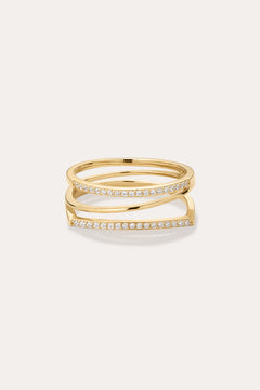 The Nola Pavé Triple Band Ring in Gold features a modern, stacked design with three gold bands, each pavé-set with sparkling diamonds, displayed against a plain light background.