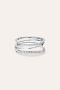 The Nola Pavé Triple Band Ring in Silver features three thin, parallel pavé bands set with sparkling white stones, connected at the sides and displayed on a plain light background.