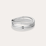 The Noor Pavé Triple Band Ring in Silver showcases a modern overlapping design with a polished finish and a row of sparkling pavé diamonds along one edge, elegantly set against a light background.