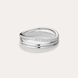 The Noor Pavé Triple Band Ring in Silver showcases a modern overlapping design with a polished finish and a row of sparkling pavé diamonds along one edge, elegantly set against a light background.