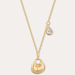 The Nora Double Pendant Necklace in Gold features a smooth sculptural pendant and a delicate teardrop charm with clear cubic zirconia, displayed on a plain light background.