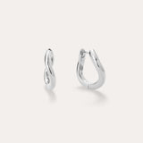 A pair of small, polished Nori Twisted Hoop Earrings in Silver with an infinity-like twist design, displayed on a light background. One sterling silver hoop faces front; the other is sideways to show the clasp.