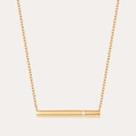 The Regina Horizontal Bar Pendant Necklace in Gold features a minimalist horizontal bar with an off-center cubic zirconia, making it perfect for lovers of simple, elegant jewelry.