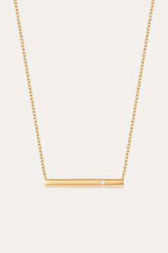 The Regina Horizontal Bar Pendant Necklace in Gold features a minimalist horizontal bar with an off-center cubic zirconia, making it perfect for lovers of simple, elegant jewelry.