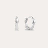 The Colette Droop Link Huggie Earrings in Silver are shown against a white background, with one earring facing front and the other from the side to display their sleek, polished, and minimalist design—ideal for everyday wear.