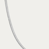 The Estelle Herringbone Chain Necklace in Silver is showcased on a plain white background, emphasizing its elegant and timeless style.