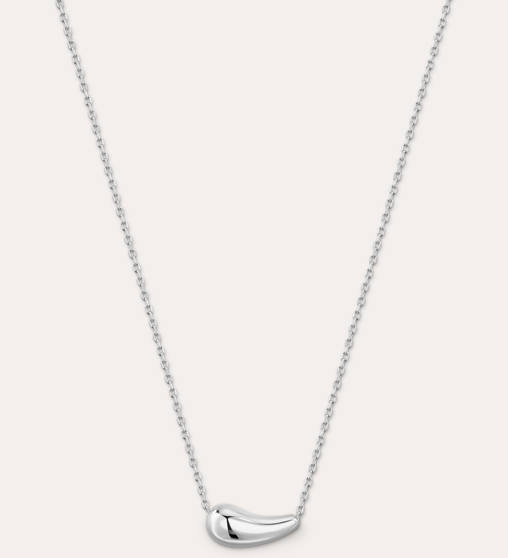 Silver necklace with a curved pendant on a light gray background