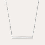 The Regina Horizontal Bar Pendant Necklace in Silver features a minimalist silver bar with a single, sparkling cubic zirconia at its center—ideal for lovers of simple, elegant jewelry.