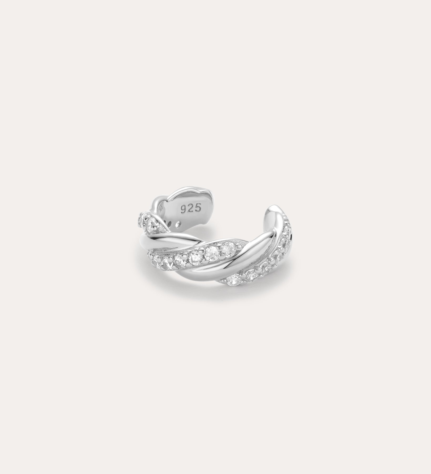 The Vera Twisted Crystal Ear Cuff in Silver is an adjustable sterling silver (stamped 925) ring with a twisted design and embedded clear gemstones, displayed on a plain light background.